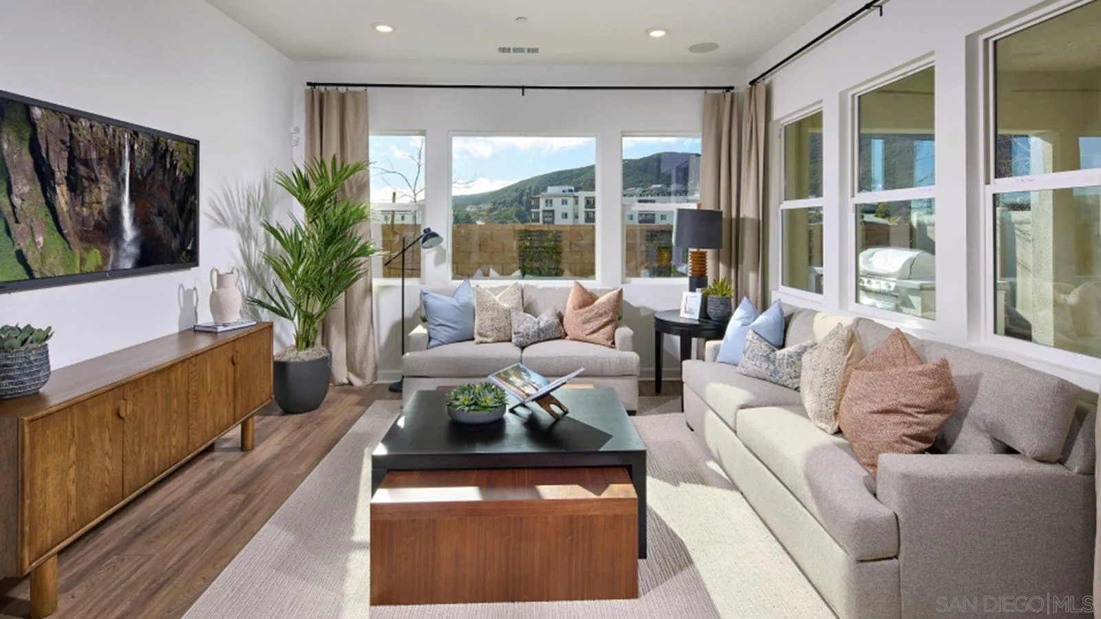 15366 Junipers Drive San Diego, CA 92129 - Photo 18 of 19 a living room with furniture large window and potted plants