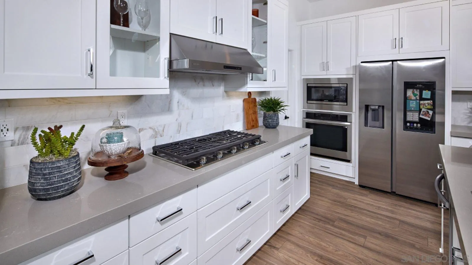 15366 Junipers Drive San Diego, CA 92129 - Photo 4 of 19 a kitchen with stainless steel appliances a sink a stove and cabinets