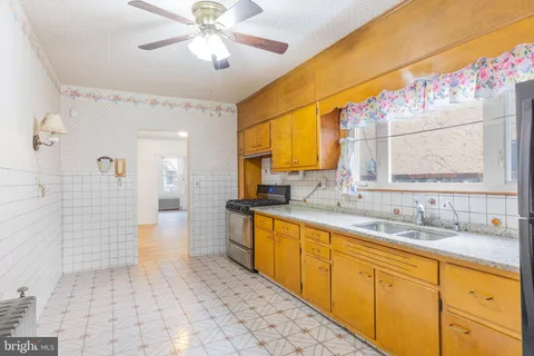 a spacious bathroom with a sink a mirror and a shower