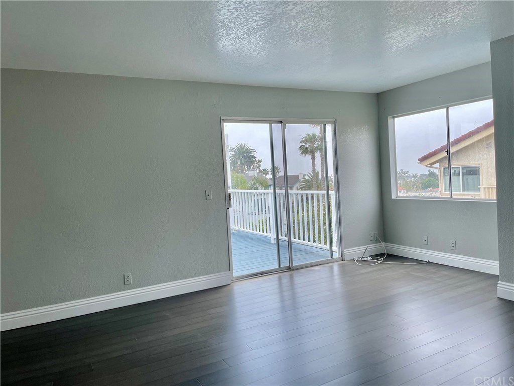 33881 Orilla Road Dana Point, CA 92629 - Photo 17 of 20 an empty room with wooden floor and windows
