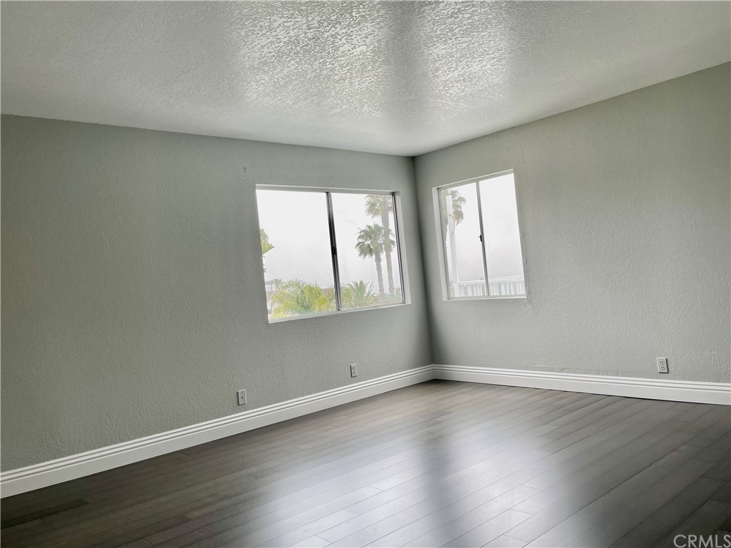 33881 Orilla Road Dana Point, CA 92629 - Photo 18 of 20 an empty room with wooden floor and windows