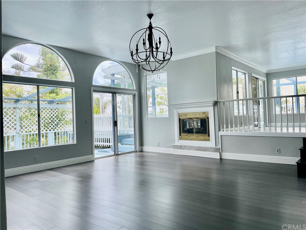 33881 Orilla Road Dana Point, CA 92629 - Photo 2 of 20 an empty room with wooden floor fireplace and windows