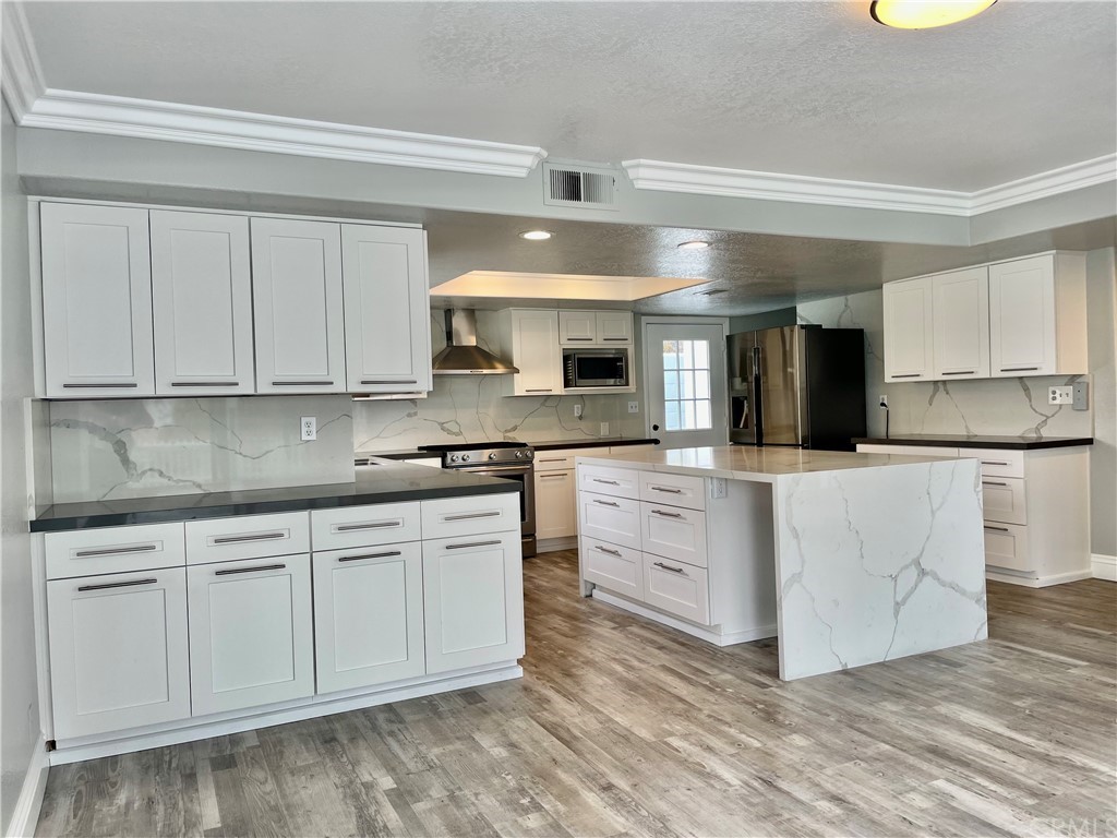 33881 Orilla Road Dana Point, CA 92629 - Photo 3 of 20 a kitchen with white cabinets and sink