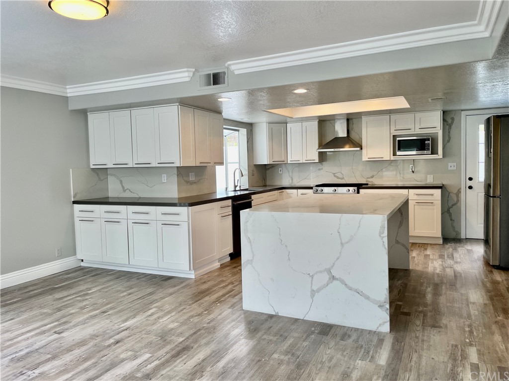 33881 Orilla Road Dana Point, CA 92629 - Photo 4 of 20 a kitchen with stainless steel appliances granite countertop a sink and cabinets