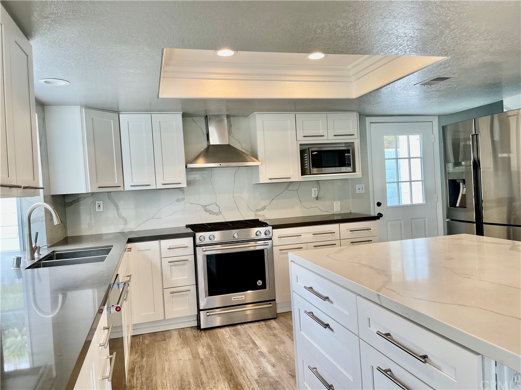 33881 Orilla Road Dana Point, CA 92629 - Photo 9 of 20 a kitchen with stainless steel appliances granite countertop a stove a sink and a microwave