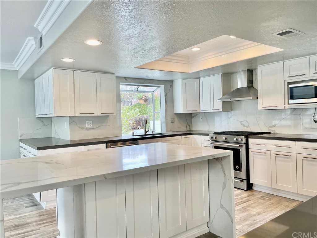 33881 Orilla Road Dana Point, CA 92629 - Photo 10 of 20 a kitchen with stainless steel appliances granite countertop a sink a stove and cabinets