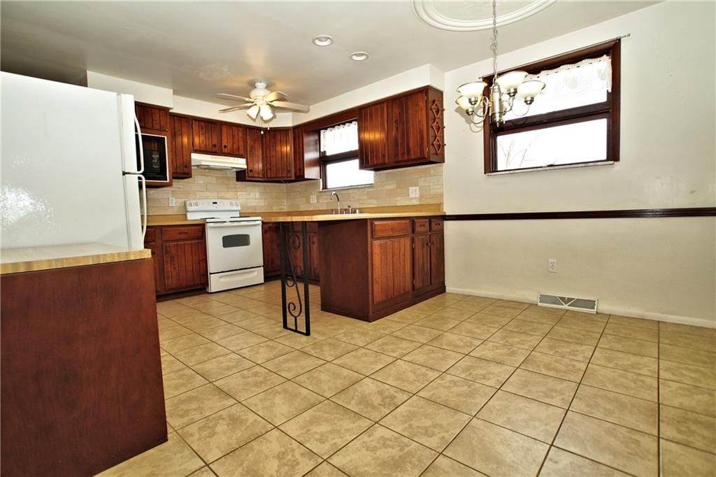 2156 Denmark Manor Road Export, PA 15632 - Photo 8 of 16 a kitchen with stainless steel appliances granite countertop a refrigerator and a stove top oven