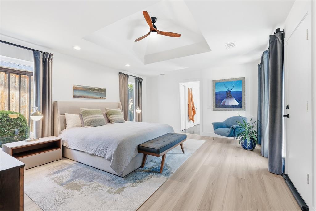 5516 Bent Trail Dallas, TX 75248 - Photo 14 of 32 a bedroom with a bed and a chandelier