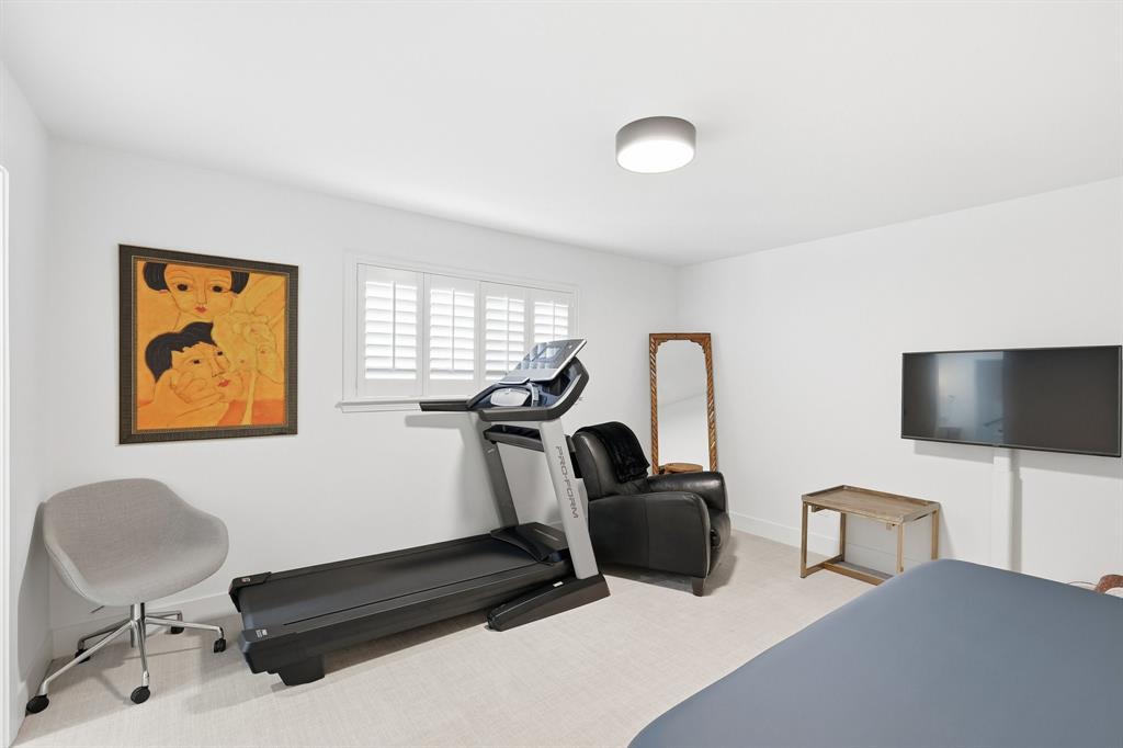 5516 Bent Trail Dallas, TX 75248 - Photo 20 of 32 a room with gym equipment and a flat screen tv