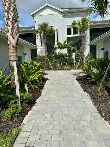 a kitchen with kitchen island granite countertop a table chairs sink and cabinets