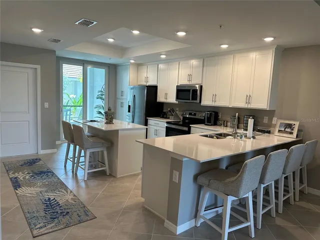 a kitchen with a sink a microwave a stove and refrigerator