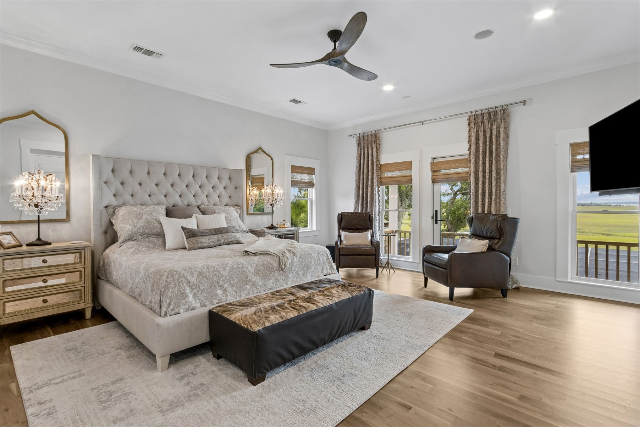 12 Marsh Point Road Fernandina Beach, FL 32034 - Photo 9 of 79 a spacious bedroom with a bed a couch and a flat screen television