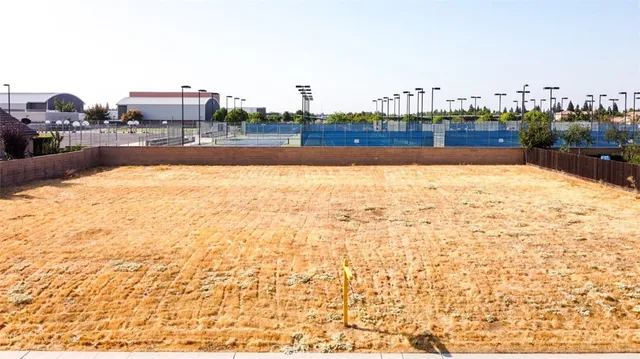 a view of swimming pool with outdoor seating and buildings in the background