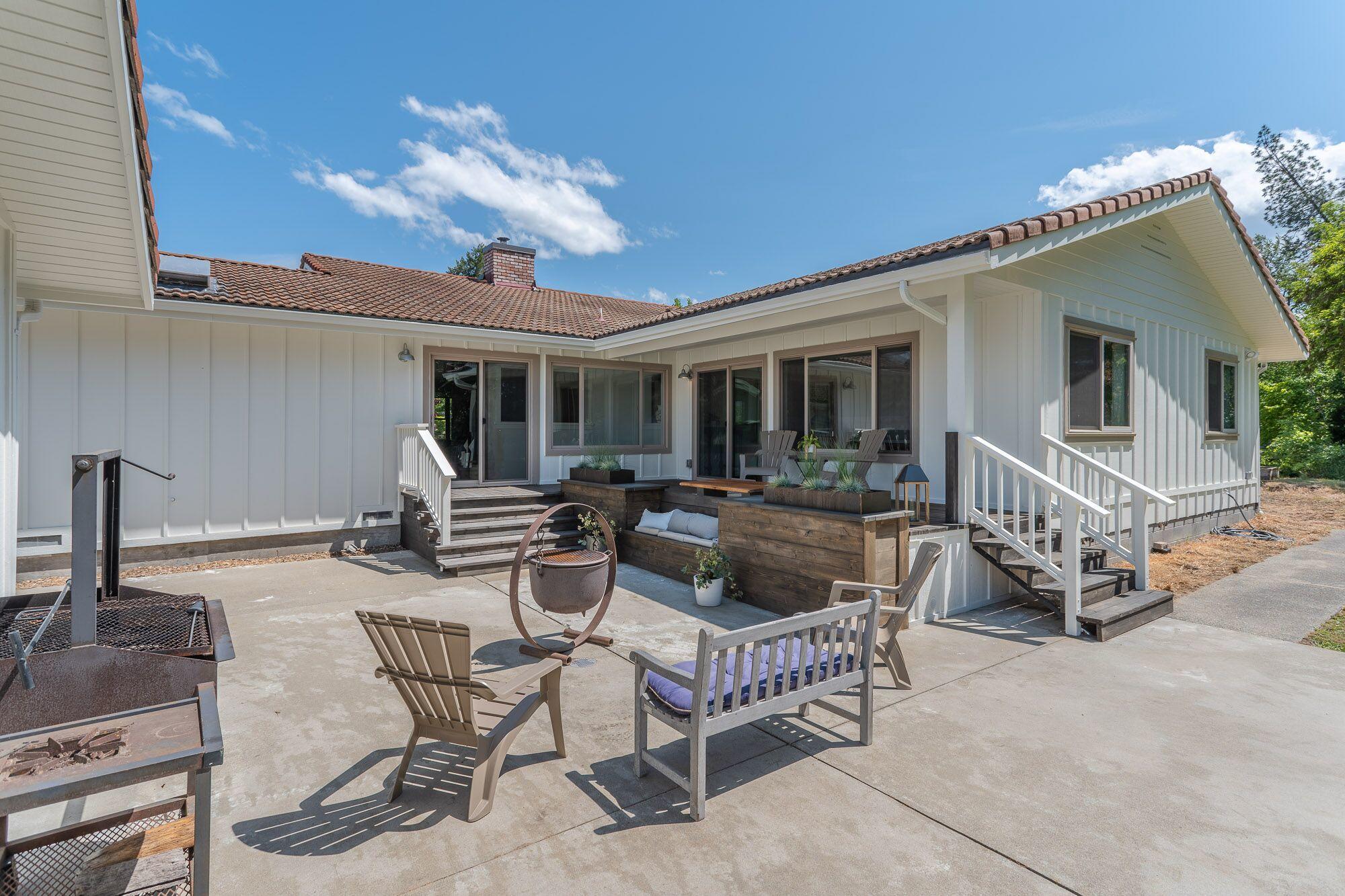 3134 South River Road Grants Pass, OR 97527 - Photo 25 of 38 a view of a house with patio and a garden
