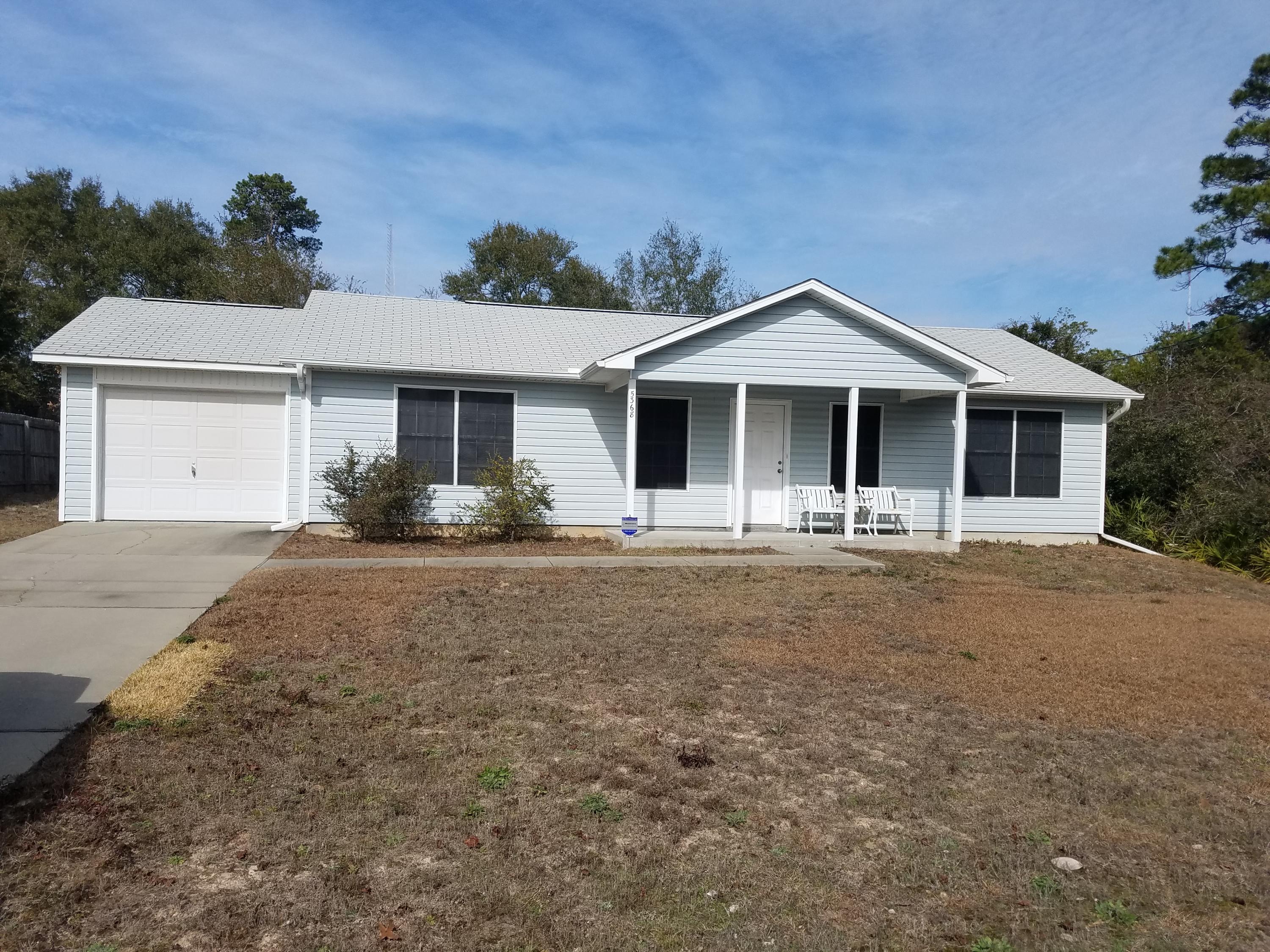 5368 Barbarosa Road Gulf Breeze, FL 32563 - Photo 1 of 17 a front view of a house with garden