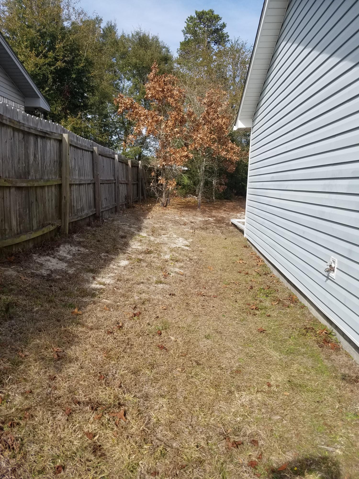 5368 Barbarosa Road Gulf Breeze, FL 32563 - Photo 2 of 17 a backyard of a house with lots of green space