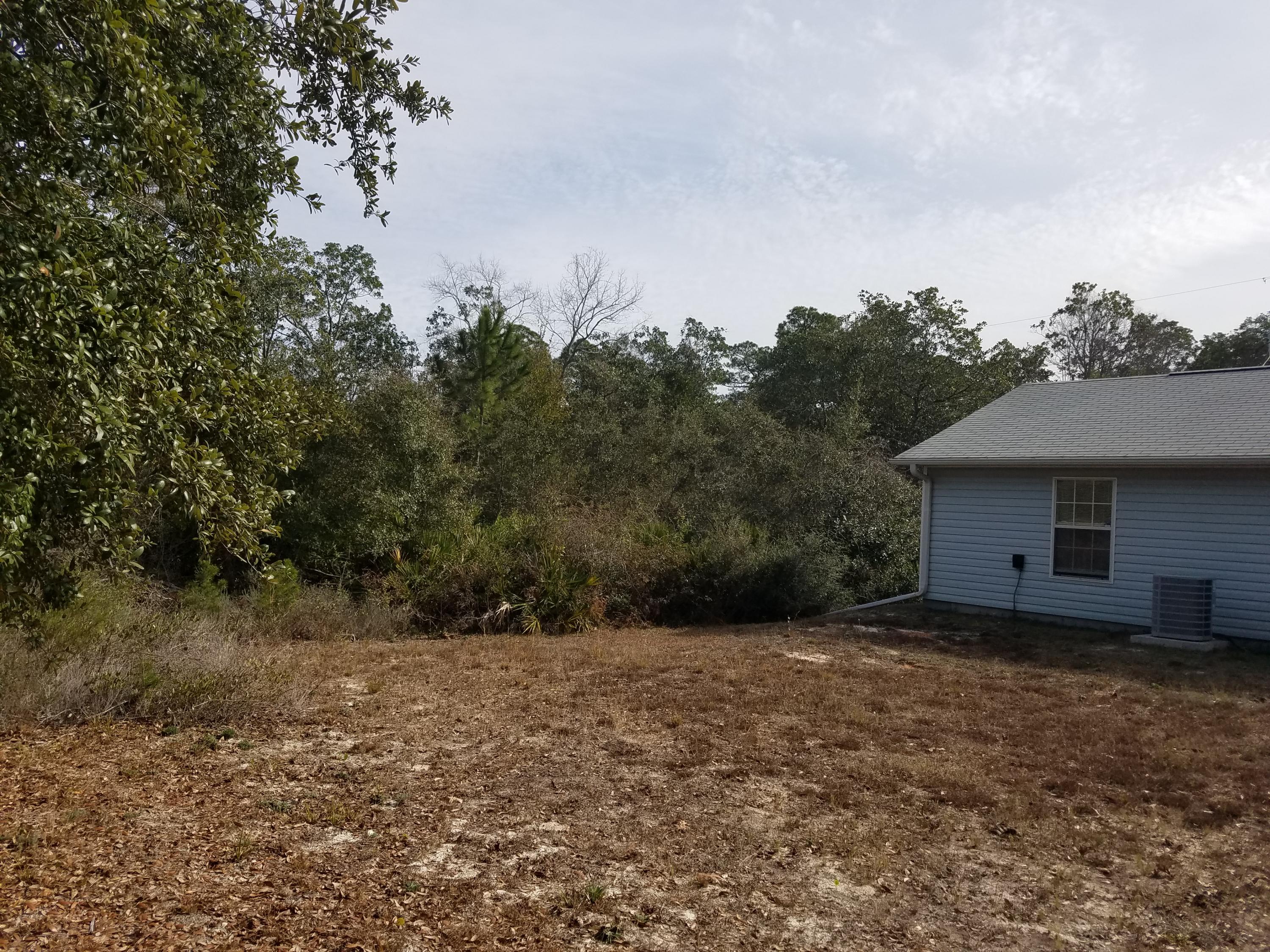 5368 Barbarosa Road Gulf Breeze, FL 32563 - Photo 4 of 17 a view of a backyard with large trees