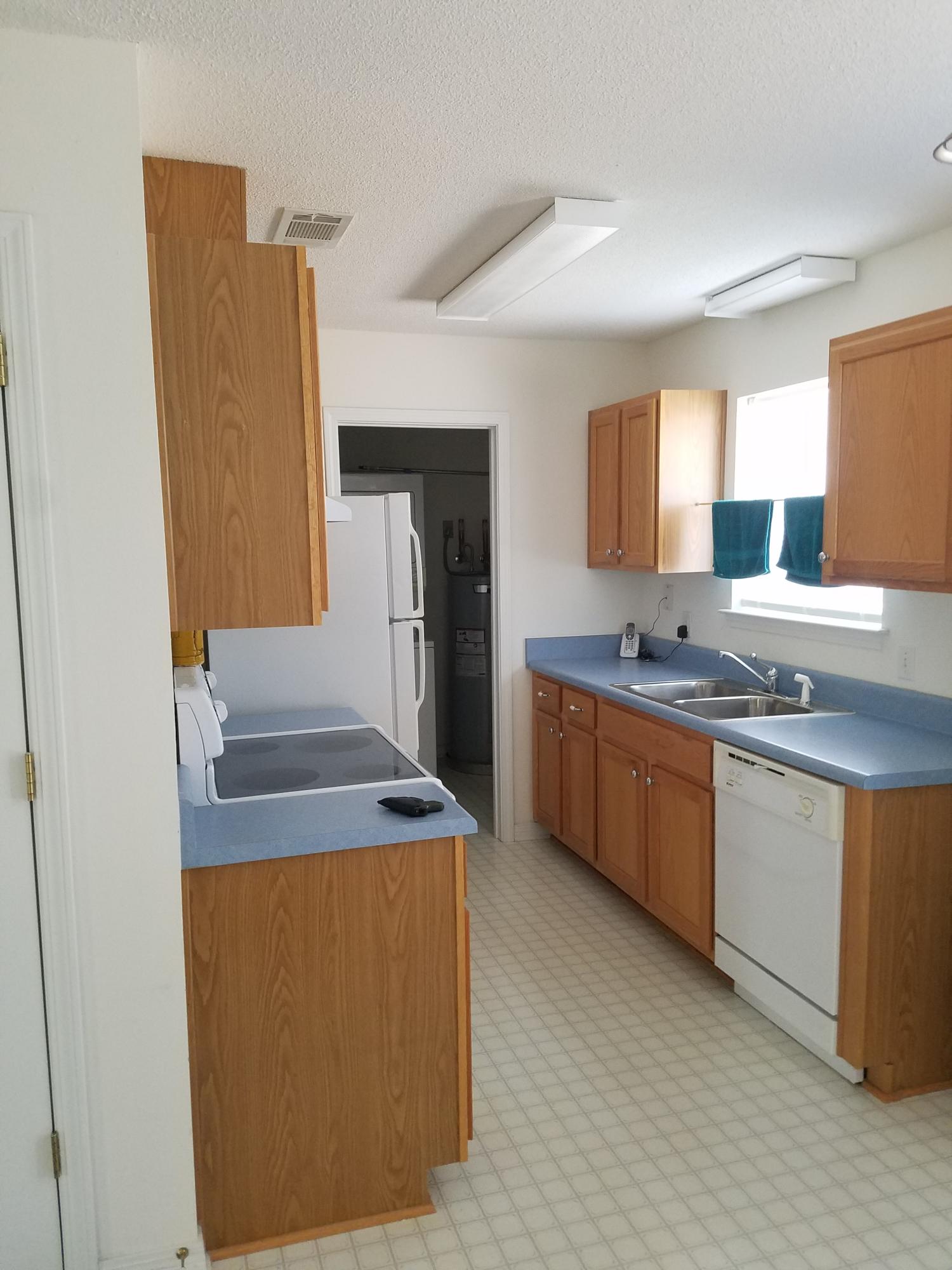 5368 Barbarosa Road Gulf Breeze, FL 32563 - Photo 8 of 17 a kitchen with stainless steel appliances granite countertop a stove a sink and a refrigerator