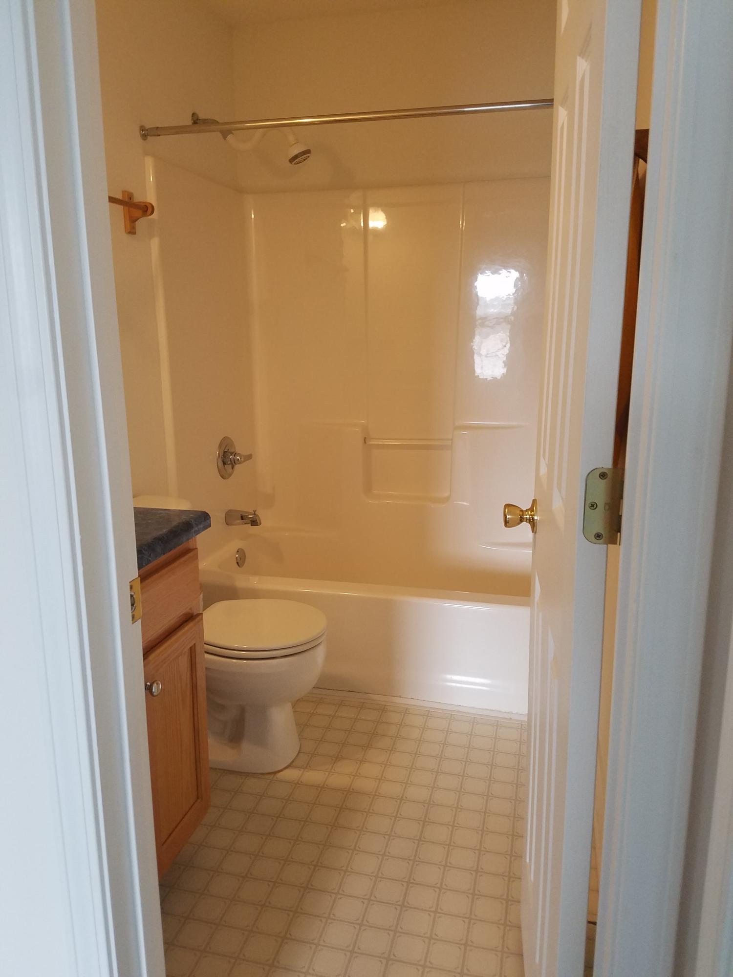 5368 Barbarosa Road Gulf Breeze, FL 32563 - Photo 9 of 17 a bathroom with a granite countertop bathtub shower a toilet and a sink