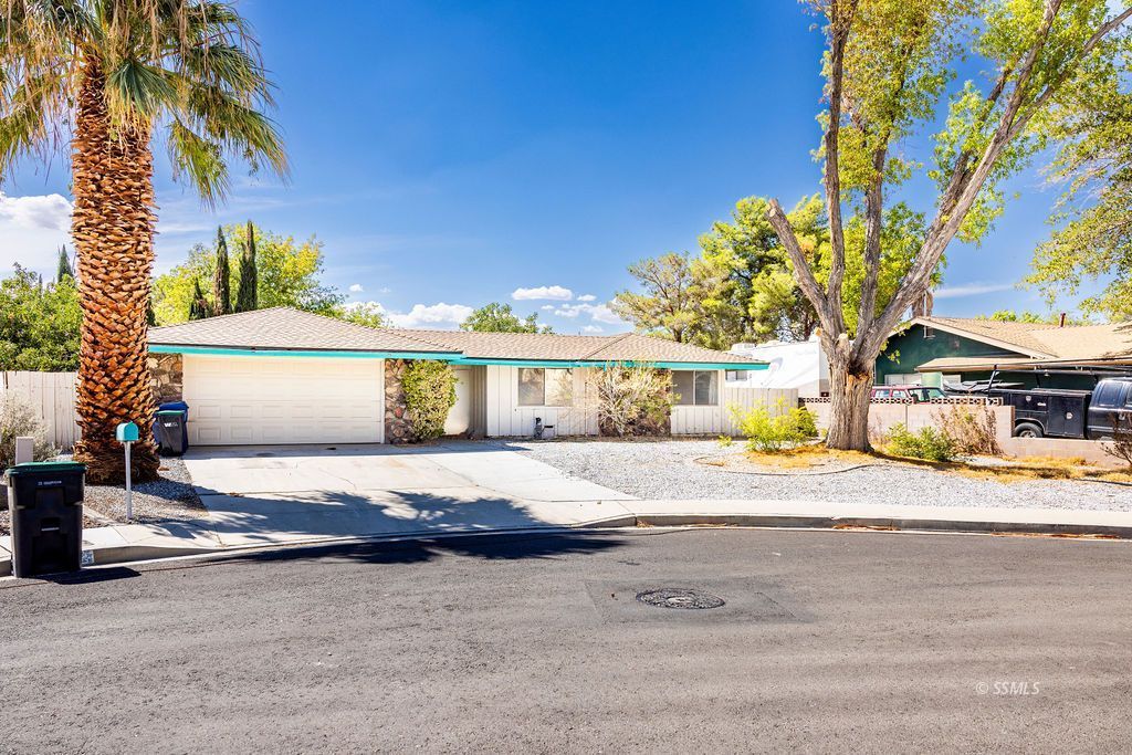 1243 Wayne Street Ridgecrest, CA 93555 - Photo 2 of 42 a view of a house with a yard and garage