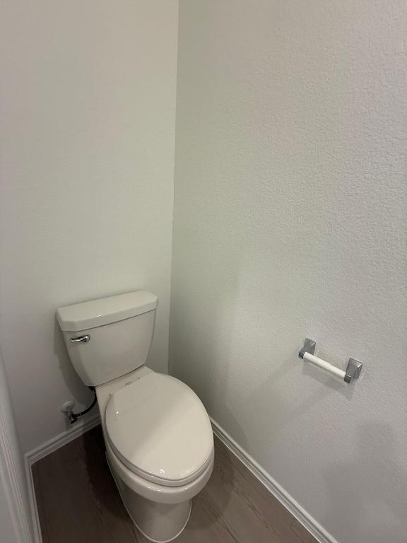 962 Soapstone Pass Maxwell, TX 78656 - Photo 12 of 23 a white toilet sitting next to a white wall