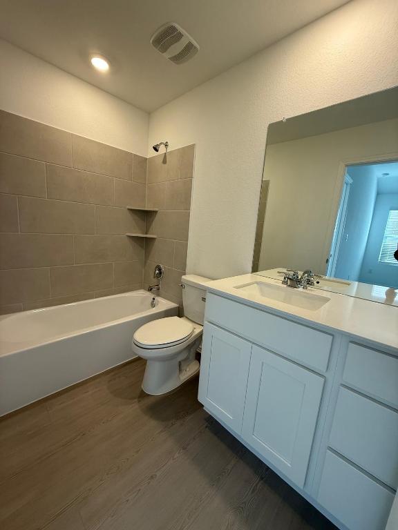 962 Soapstone Pass Maxwell, TX 78656 - Photo 16 of 23 a bathroom with a double vanity sink toilet and a bathtub