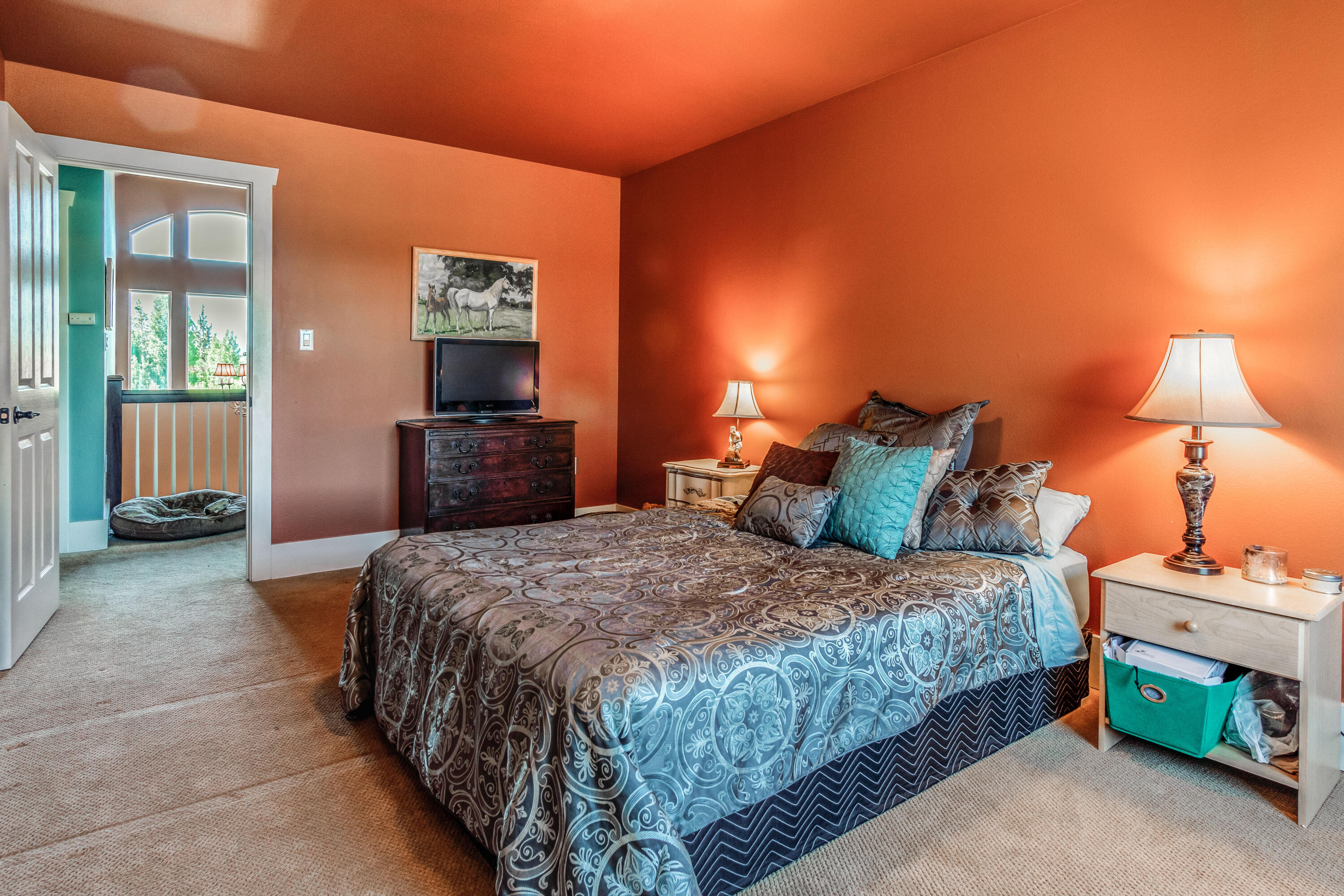 22234 Nelson Road Bend, OR 97701 - Photo 43 of 60 a bedroom with a bed and a lamp on dresser