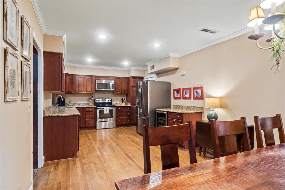4277 Sequoia Road Memphis, TN 38117 - Photo 12 of 36 a large kitchen with stainless steel appliances and a refrigerator