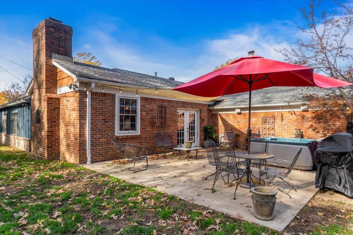 4277 Sequoia Road Memphis, TN 38117 - Photo 30 of 36 a patio with a table and chairs under an umbrella