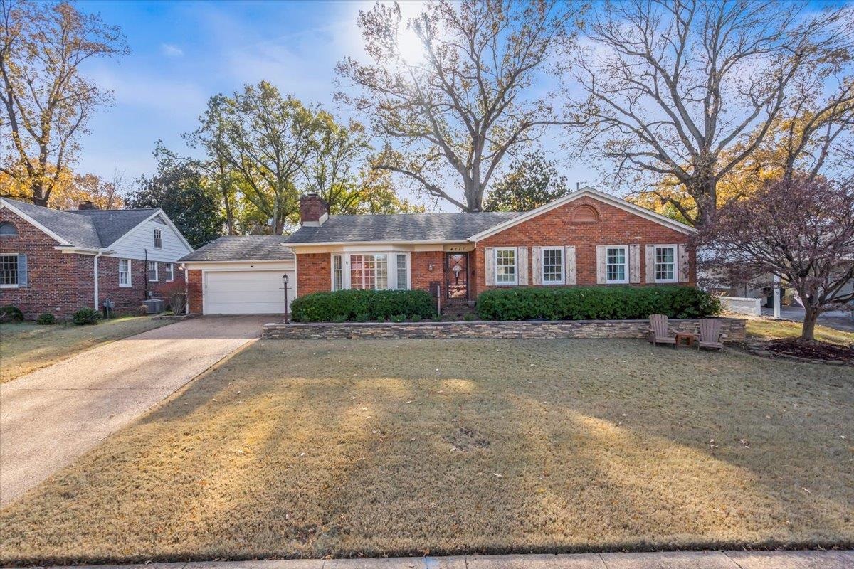 4277 Sequoia Road Memphis, TN 38117 - Photo 36 of 36 a front view of a house with a yard and garage