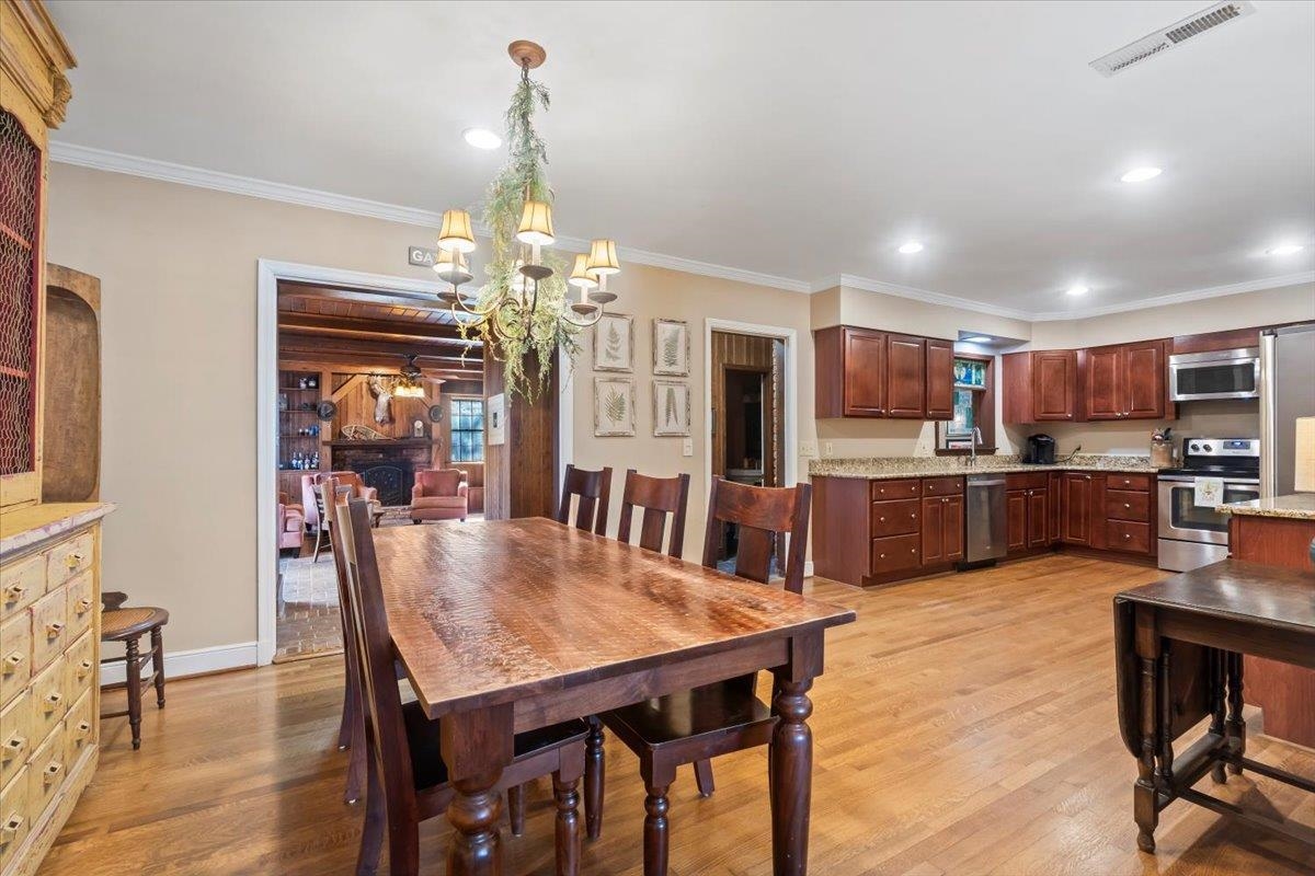 4277 Sequoia Road Memphis, TN 38117 - Photo 10 of 36 a view of a dining room with furniture and wooden floor