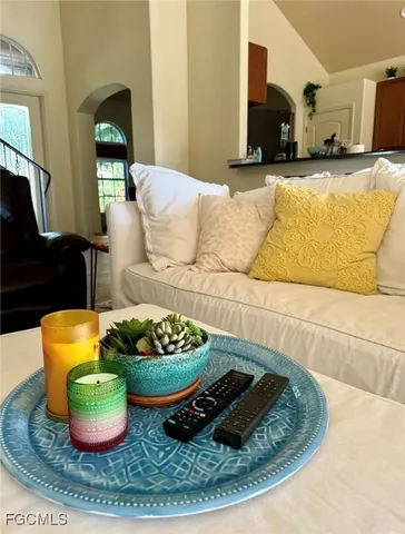 a living room with furniture kitchen and a couch