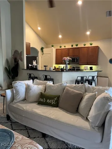 a living room with furniture and a ceiling fan