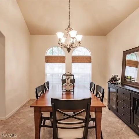 a view of a dining room with furniture and chandelier