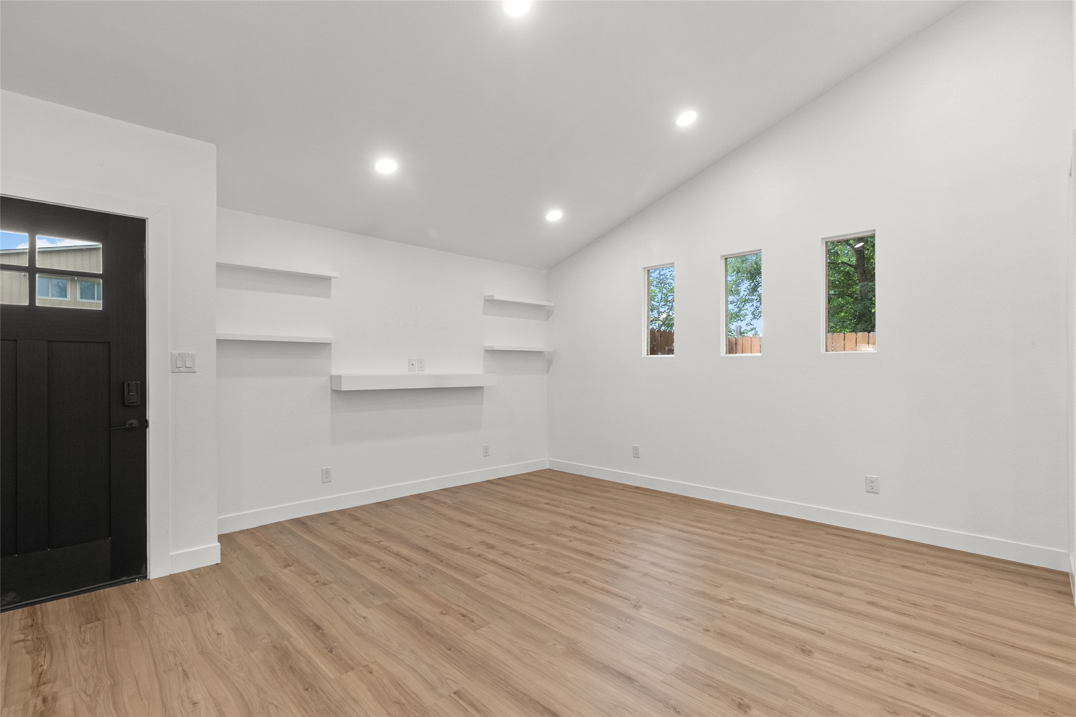 409 Ave R Marble Falls, TX 78654 - Photo 8 of 25 Vaulted ceilings, recessed lighting, and wood-finish flooring create an open atmosphere