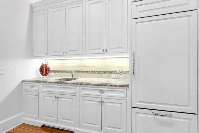 a spacious bedroom with a large bed and a wooden floor