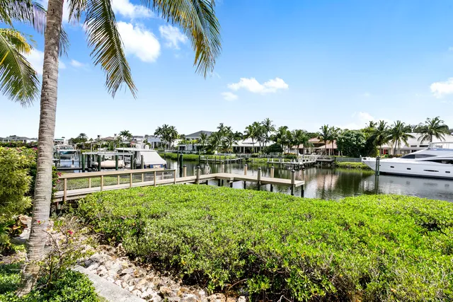 an aerial view of a city with lots of residential buildings ocean and mountain view in back