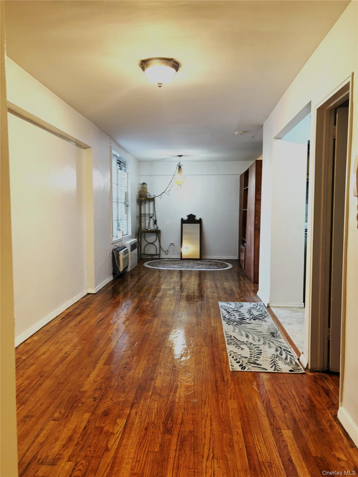 41-31 51st Street, Unit 6M Queens, NY 11377 - Photo 15 of 23 Hall featuring a wall mounted air conditioner and wood finished floors