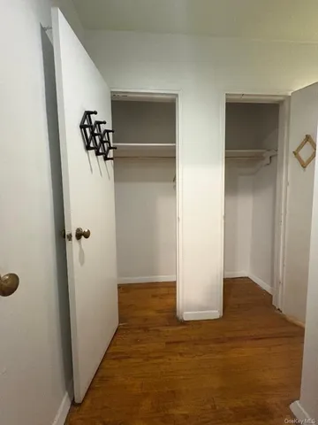 a view of a room with wooden floor