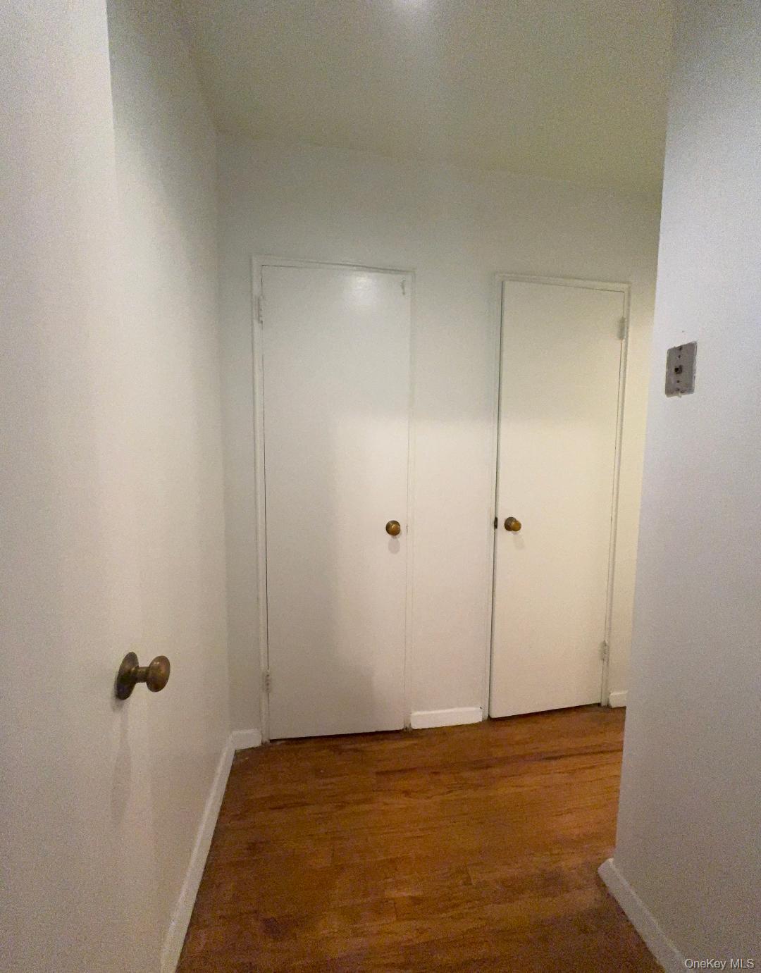 41-31 51st Street, Unit 6M Queens, NY 11377 - Photo 19 of 23 Corridor with dark wood finished floors and baseboards