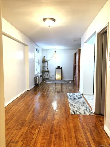 a view of a hallway with wooden floor and a fireplace