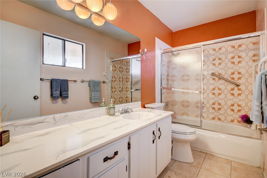 1401 Sharon Road Las Vegas, NV 89106 - Photo 47 of 73 Tiled flooring and a stone-look vanity surface define this functional bathroom space.