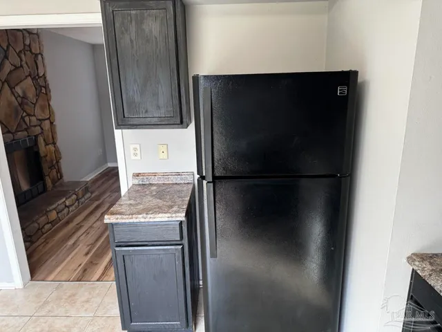 a kitchen with a refrigerator and a stove