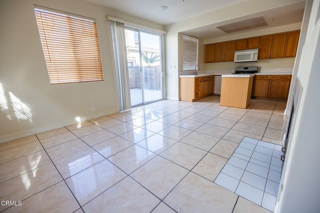 a kitchen with stainless steel appliances a sink a stove a microwave and cabinets