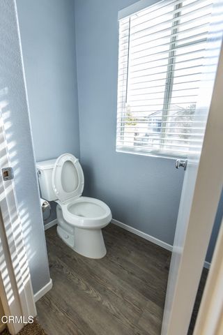 a white toilet sitting next to a window