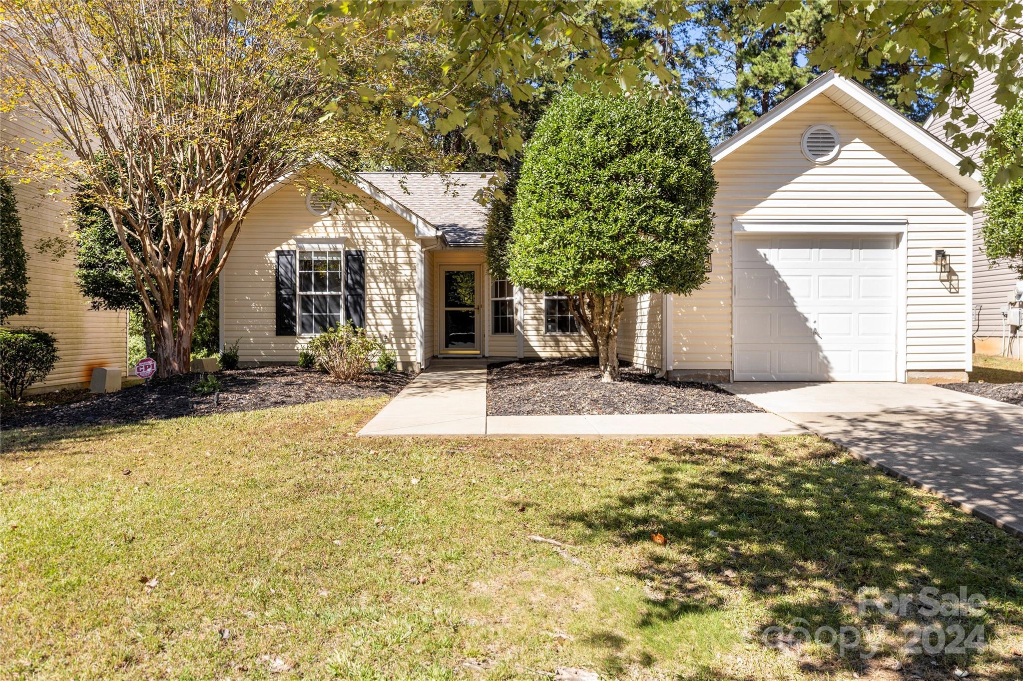 4909 Deerton Road Charlotte, NC 28269 - Photo 1 of 31 a view of a white house with a yard and large tree