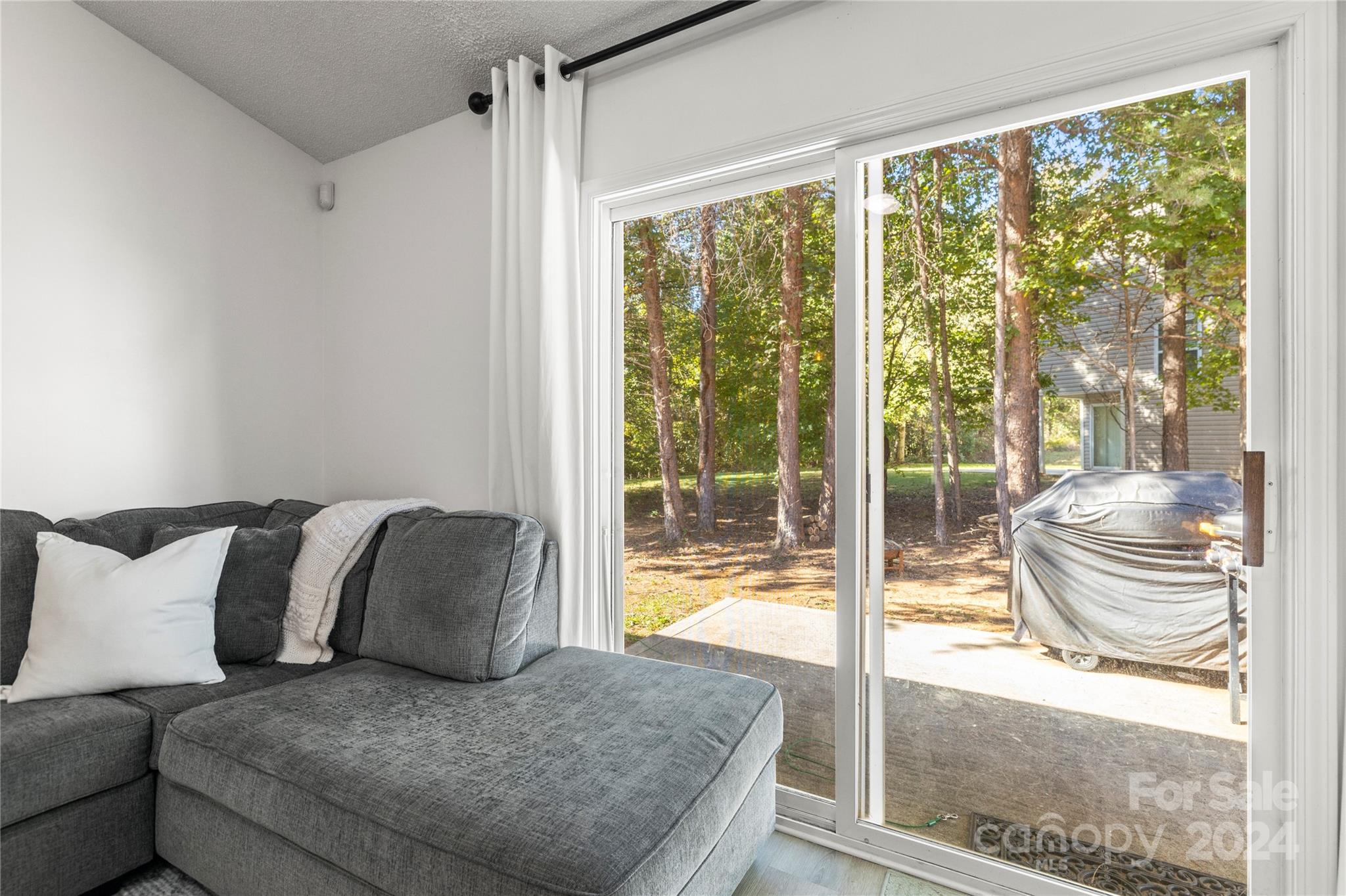 4909 Deerton Road Charlotte, NC 28269 - Photo 11 of 31 a living room with a large window and a couch