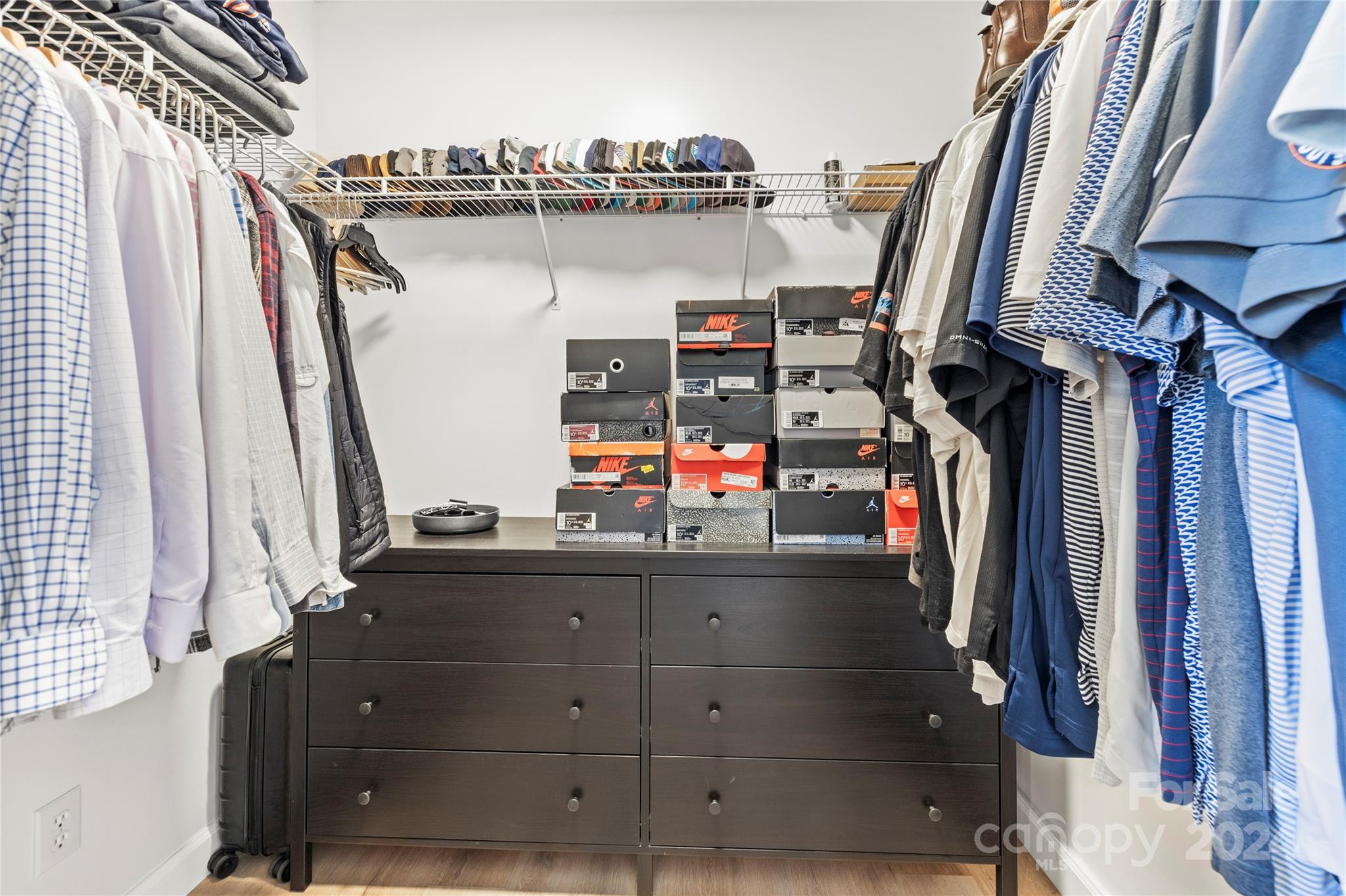 4909 Deerton Road Charlotte, NC 28269 - Photo 17 of 31 a view of walk in closet with clothes and shoes