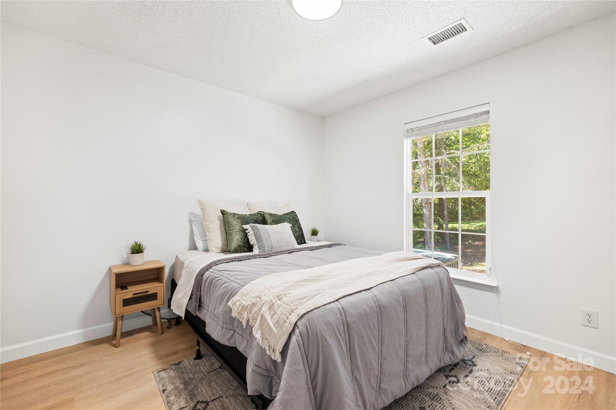 4909 Deerton Road Charlotte, NC 28269 - Photo 20 of 31 a bedroom with a bed and a window