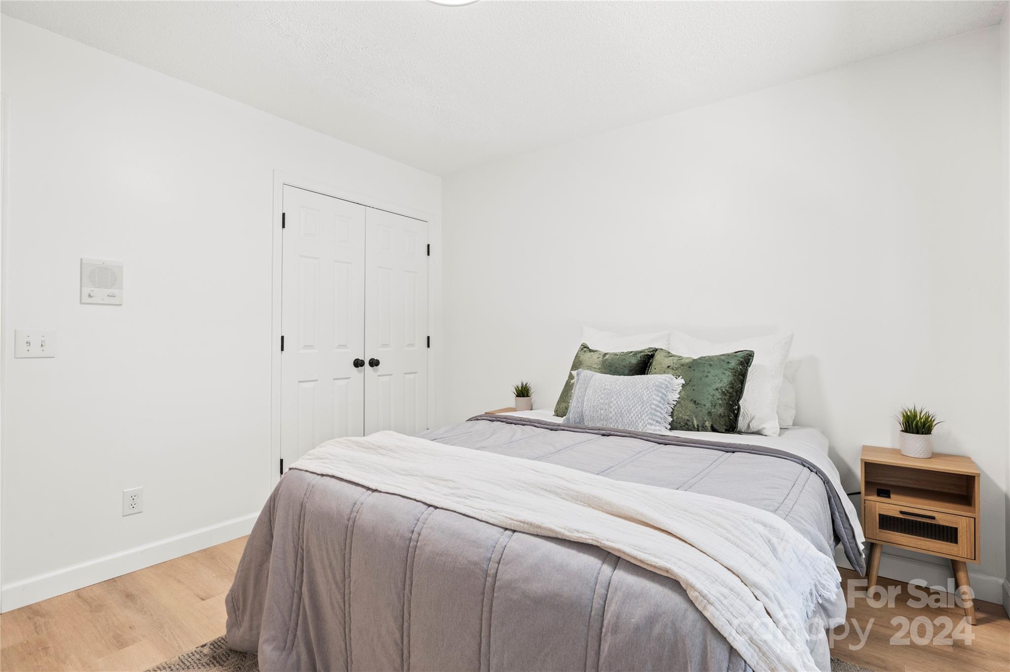 4909 Deerton Road Charlotte, NC 28269 - Photo 21 of 31 a bedroom with a bed and a wall painting